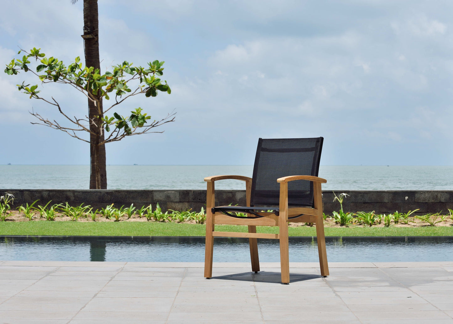 Rinjani rectangular teak table with Fortuna armchair poolside setting teak and black mesh on Tampa Home & Garden Store