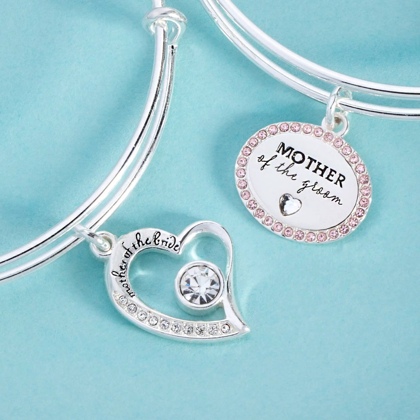 Mother of the Groom Bangle by Alex and Ani, silver bracelet with pink crystal charm on turquoise background on Tampa Home & Garden Store