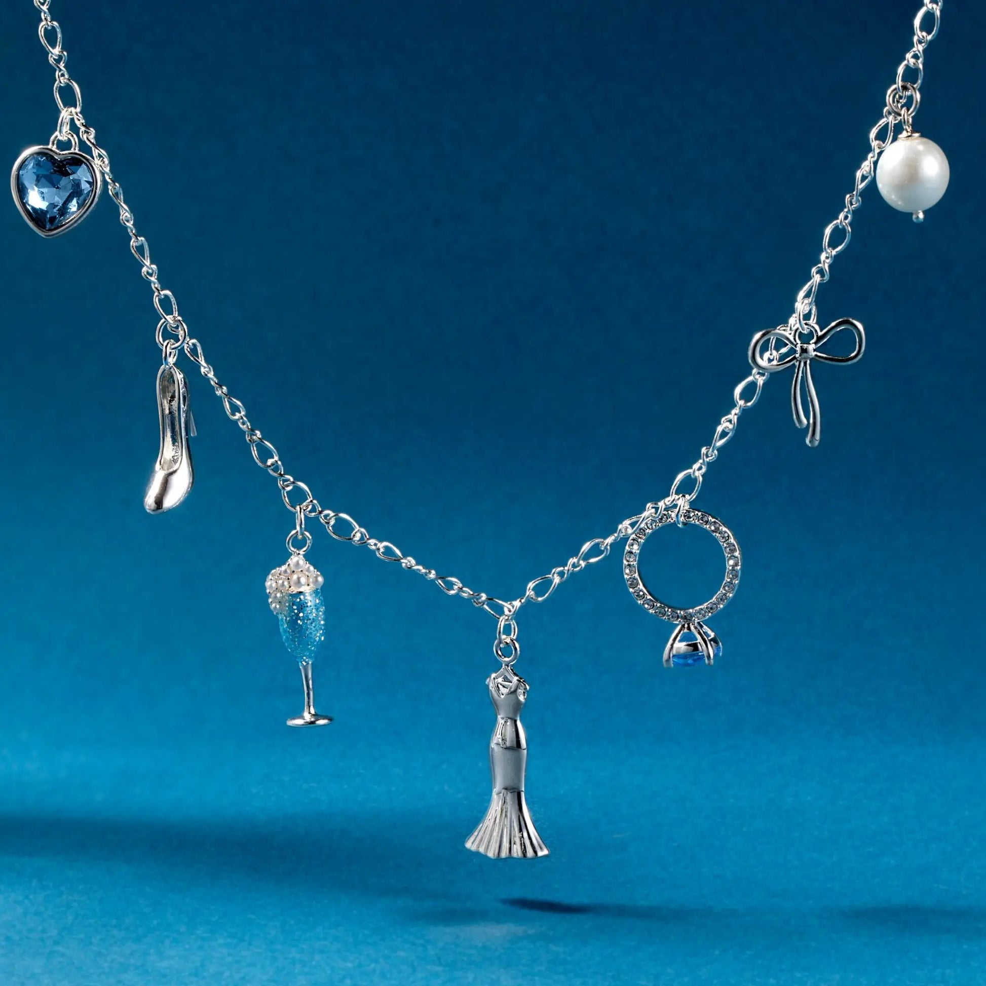 Bridal multi-charm necklace with blue heart gemstone, pearl bead, and silver charms on Tampa Home & Garden Store
