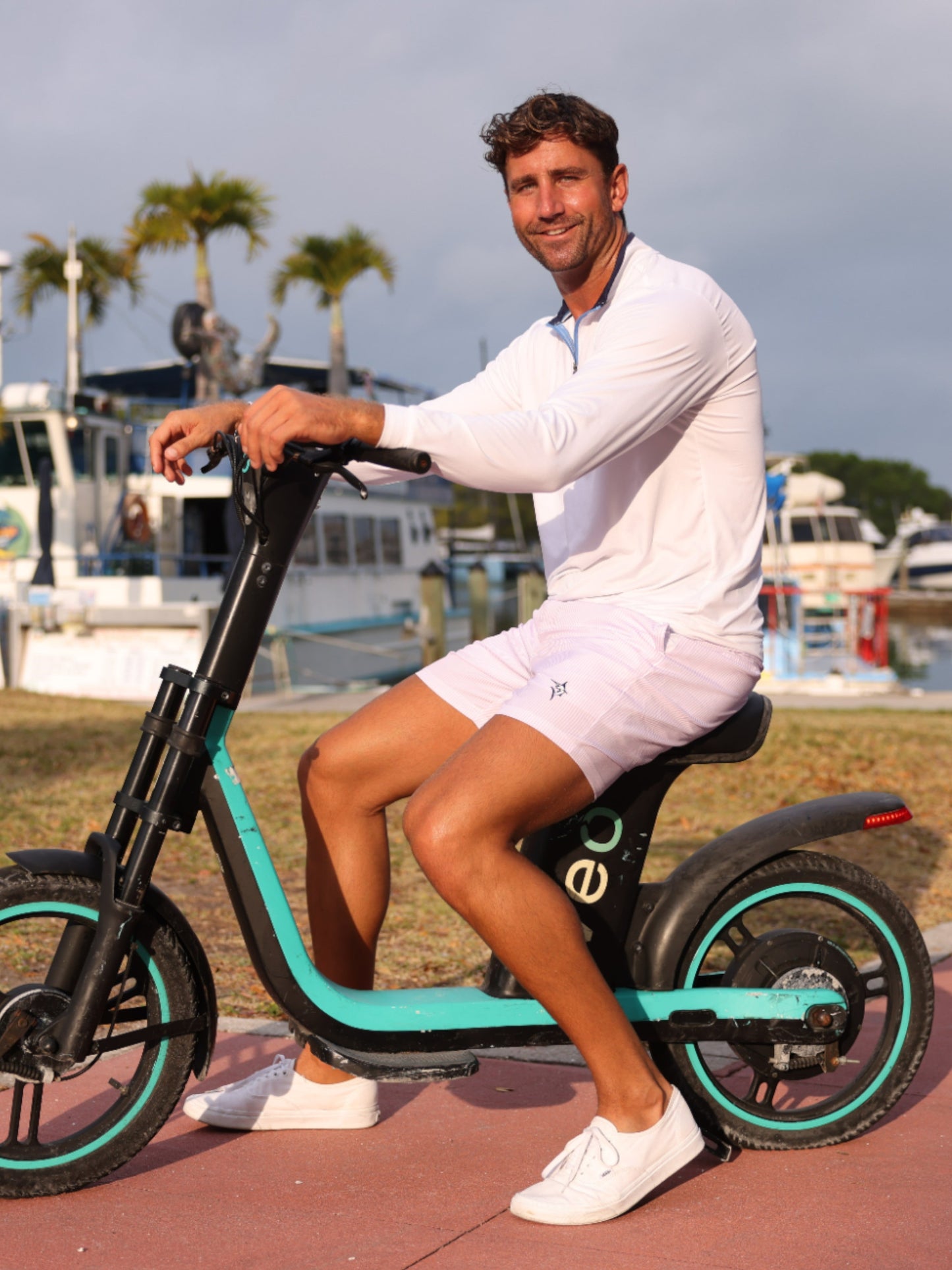Freeport Short Effortless Performance light pink shorts by White Water Life on an e-scooter on Tampa Home & Garden Store