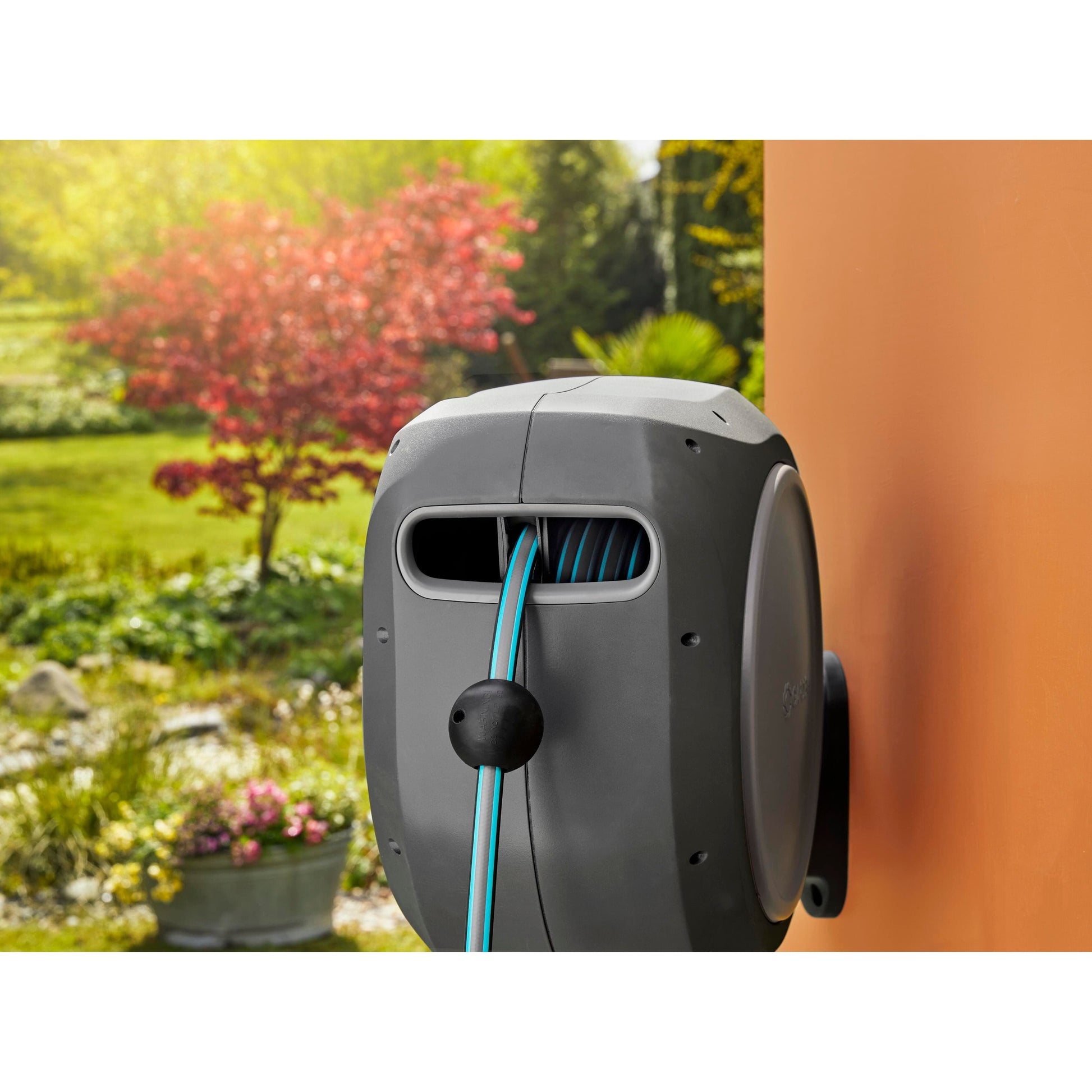 Retractable Hose Reel RollUp 50 ft Gardena gray housing with blue hose auto retracting on Tampa Home & Garden Store