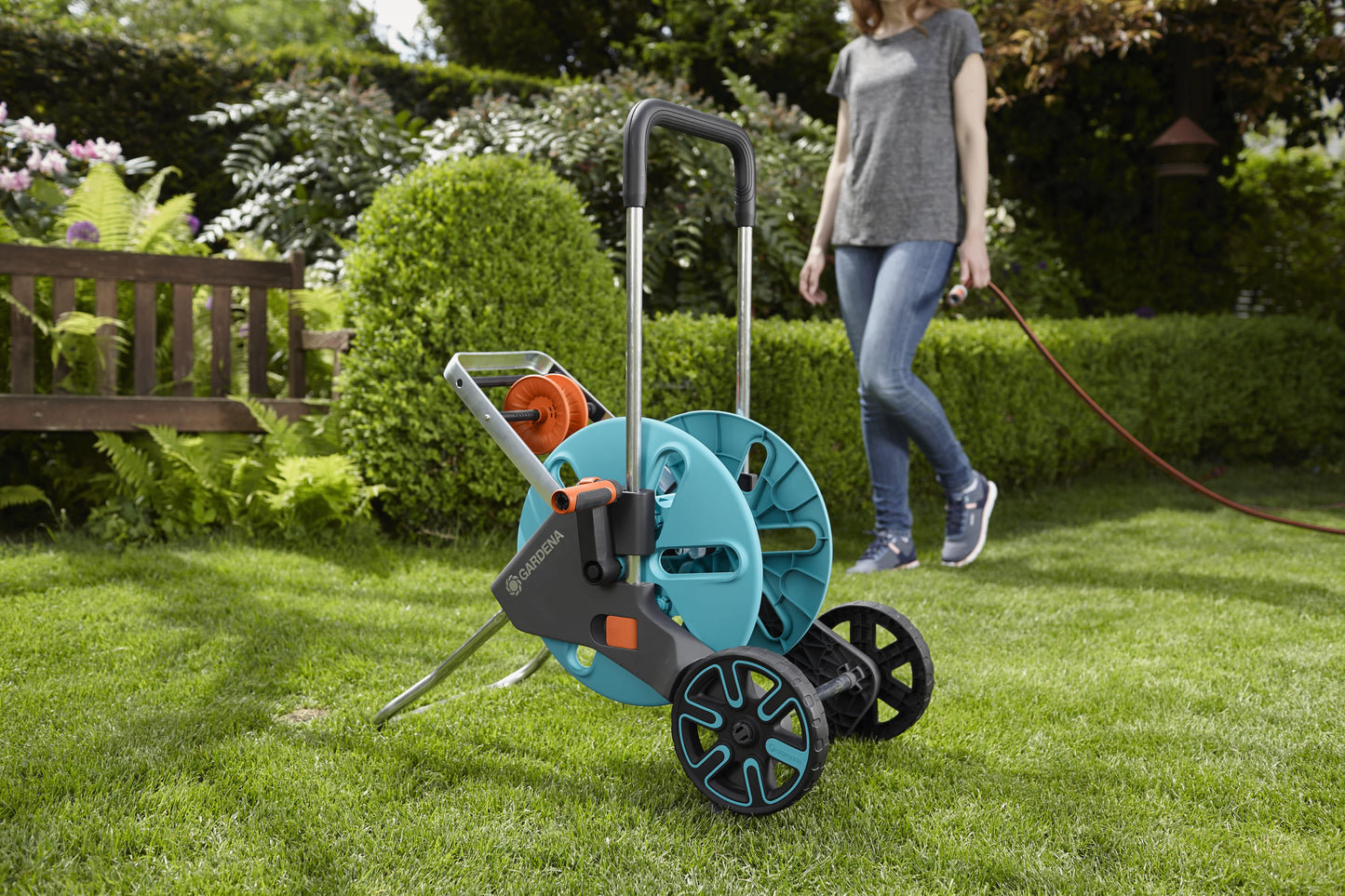 Gardena CleverRoll M Easy hose trolley turquoise reel, metal frame and twin wheels in a garden scene on Tampa Home & Garden Store