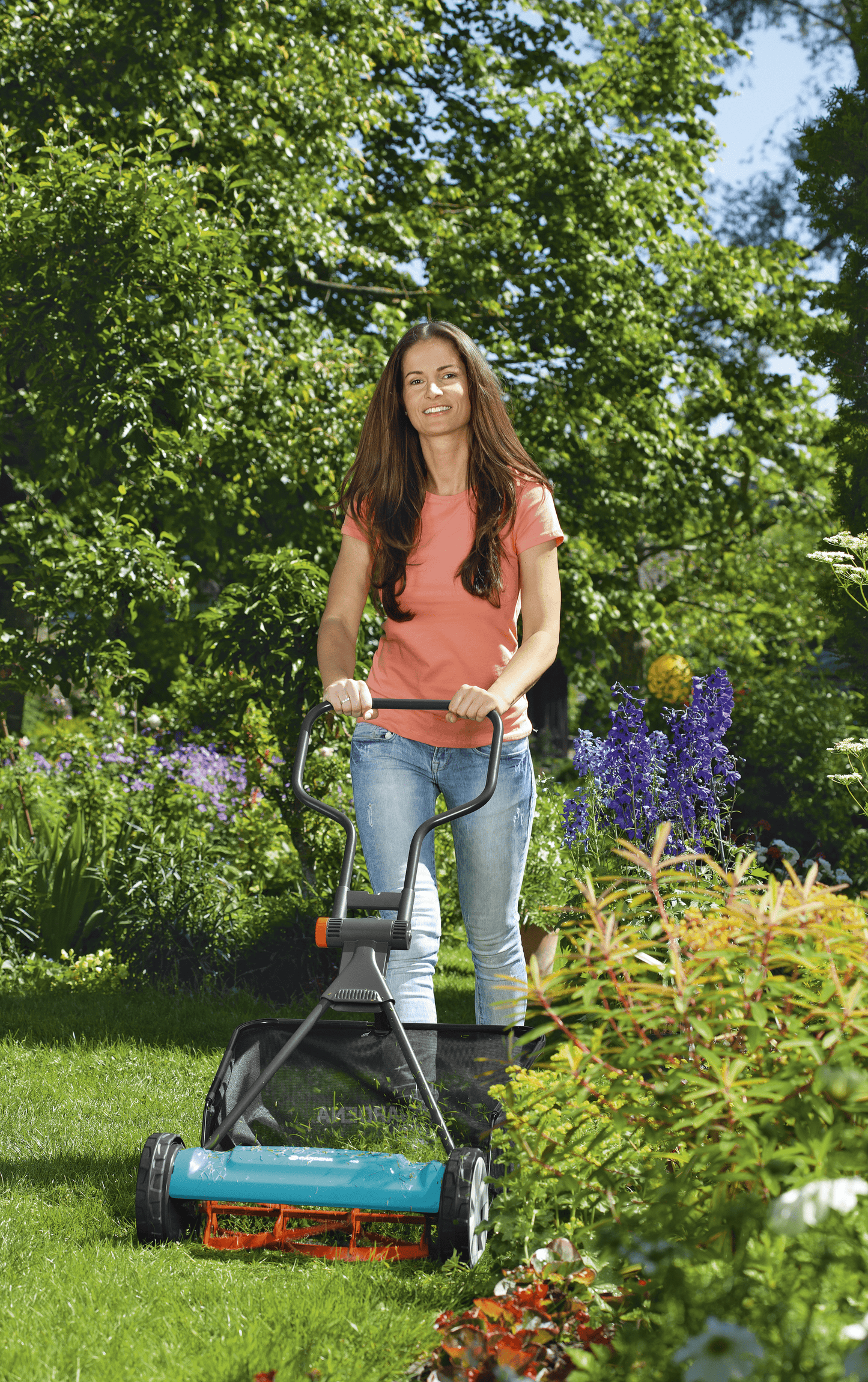 Gardena Grass Catcher with mesh bag attached to a push lawn mower in a sunny garden on Tampa Home & Garden Store