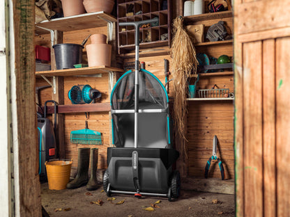 Leaf and Lawn Collector lawn sweeper by Gardena with teal accents in a wooden shed on Tampa Home & Garden Store
