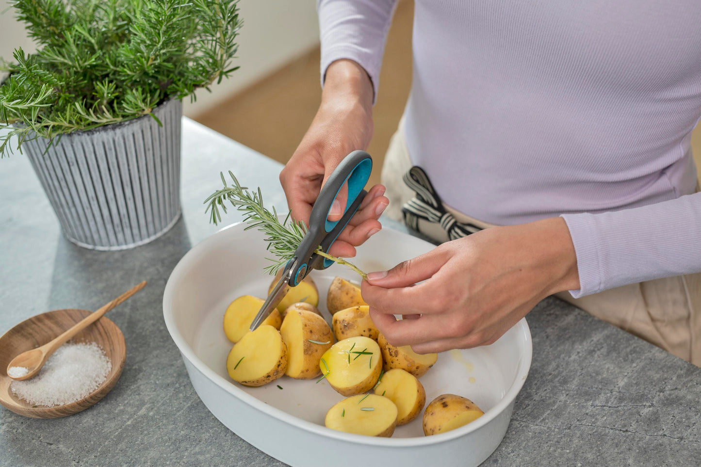 HerbCut Set by Gardena; blue-gray herb scissors trimming rosemary sprig over a bowl of potatoes on Tampa Home & Garden Store