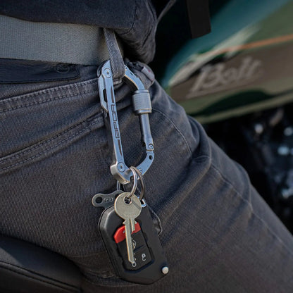 GPCA Carabiner PRO EDC multi-tool clip in metallic gray attached to a jeans belt loop on Tampa Home & Garden Store