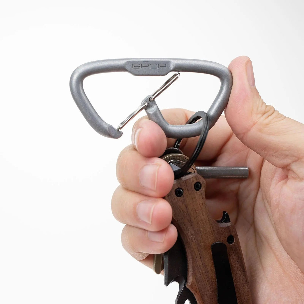 GPCA Carabiner Loop LITE EDC keychain in gray metal with clip, held in hand on Tampa Home & Garden Store