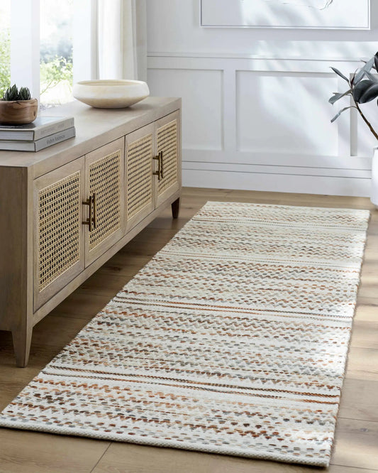 Griet Hand Woven Wool Rug by Boutique Rugs in ivory and tan woven pattern on wood floor on Tampa Home & Garden Store