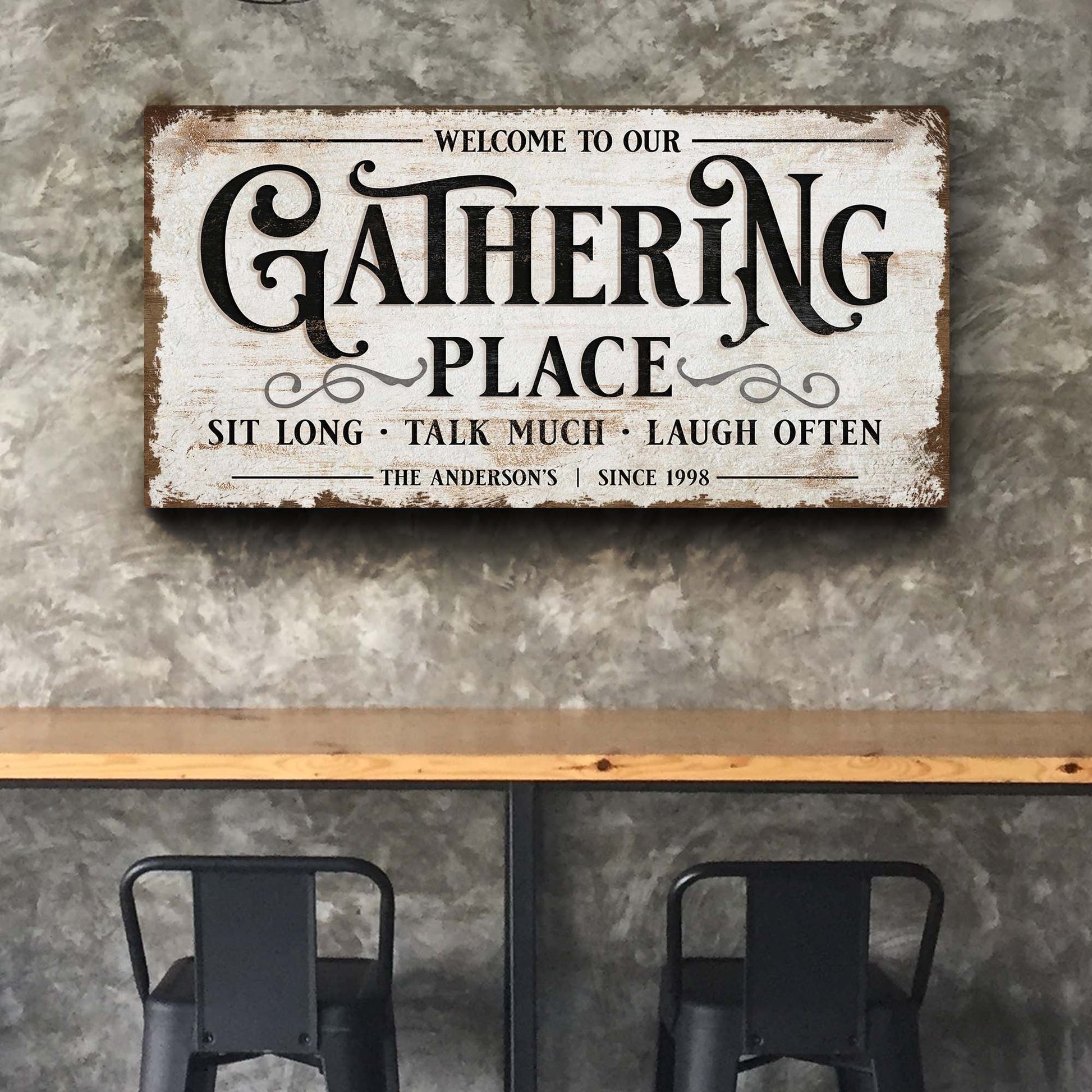 Gathering Place canvas sign with distressed white background and bold ornate black lettering on Tampa Home & Garden Store