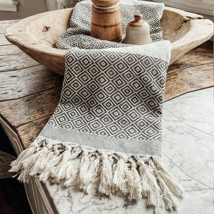 Haley Diamond Towel 200GSM by Gia Roma with black and white geometric pattern and tassels on Tampa Home & Garden Store