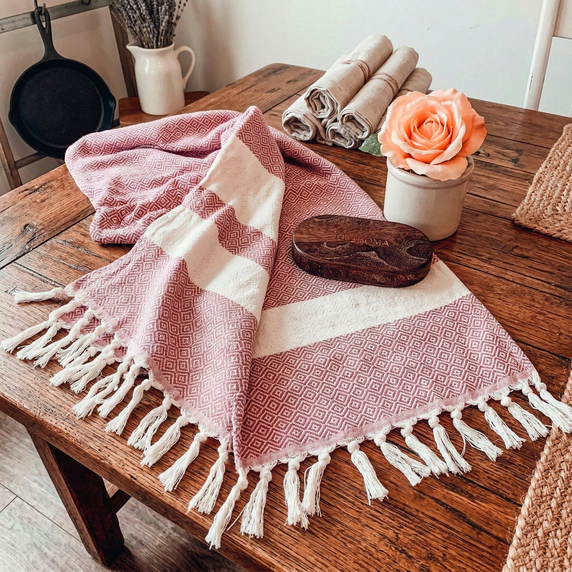 Haley Diamond Towel 200GSM Gia Roma pink geometric beach towel with fringe on wood table on Tampa Home & Garden Store
