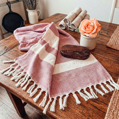 Haley Diamond Towel 200GSM Gia Roma pink geometric beach towel with fringe on wood table on Tampa Home & Garden Store