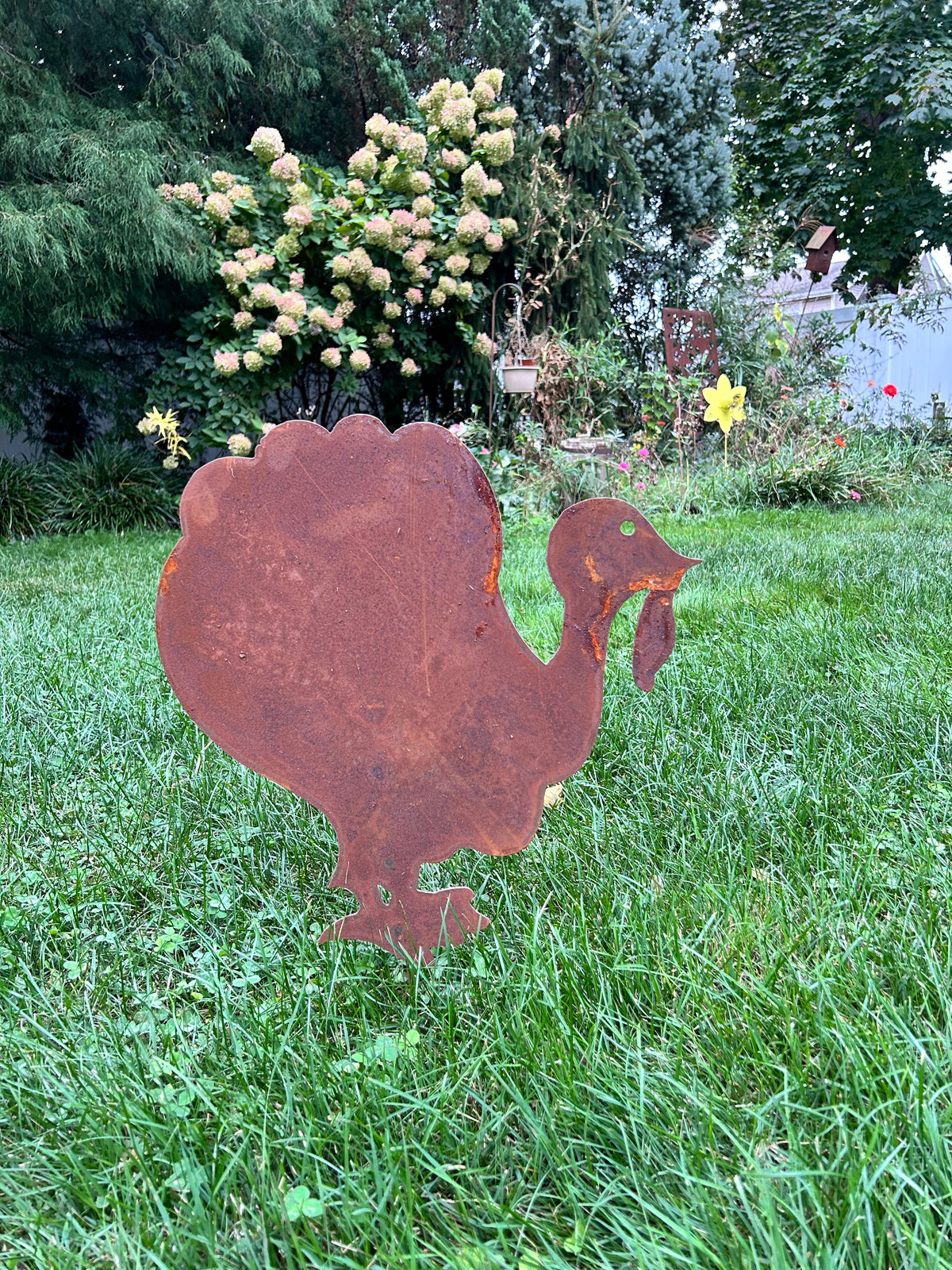 Giant rusty metal turkey decoration silhouette in a grassy yard on Tampa Home & Garden Store