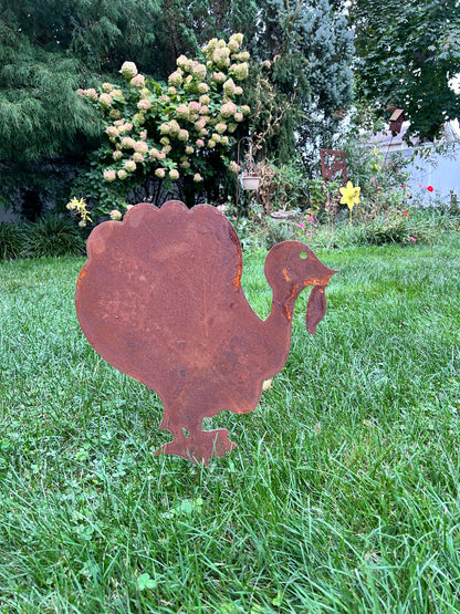 Giant rusty metal turkey decoration silhouette in a grassy yard on Tampa Home & Garden Store