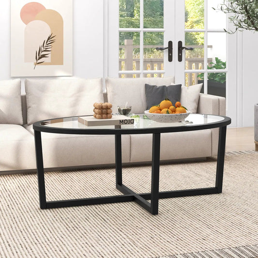 DirectDeals oval glass coffee table with black cross base in a bright living room on Tampa Home & Garden Store