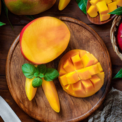 Glenn Mango Tree mango display with ripe yellow mango halves and diced cubes on wood board on Tampa Home & Garden Store