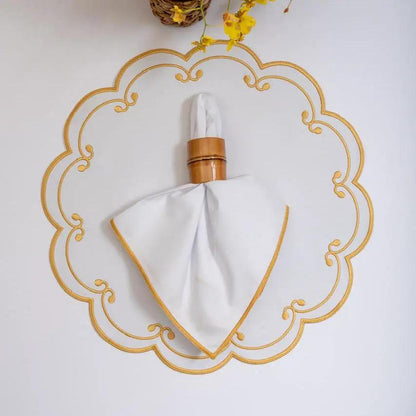 Royal placemat by Talah Home, white placemat with gold border and folded napkin on wooden ring on Tampa Home & Garden Store