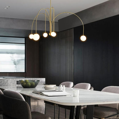Globella 6-head pendant chandelier with glass globes in gold finish over marble dining table on Tampa Home & Garden Store