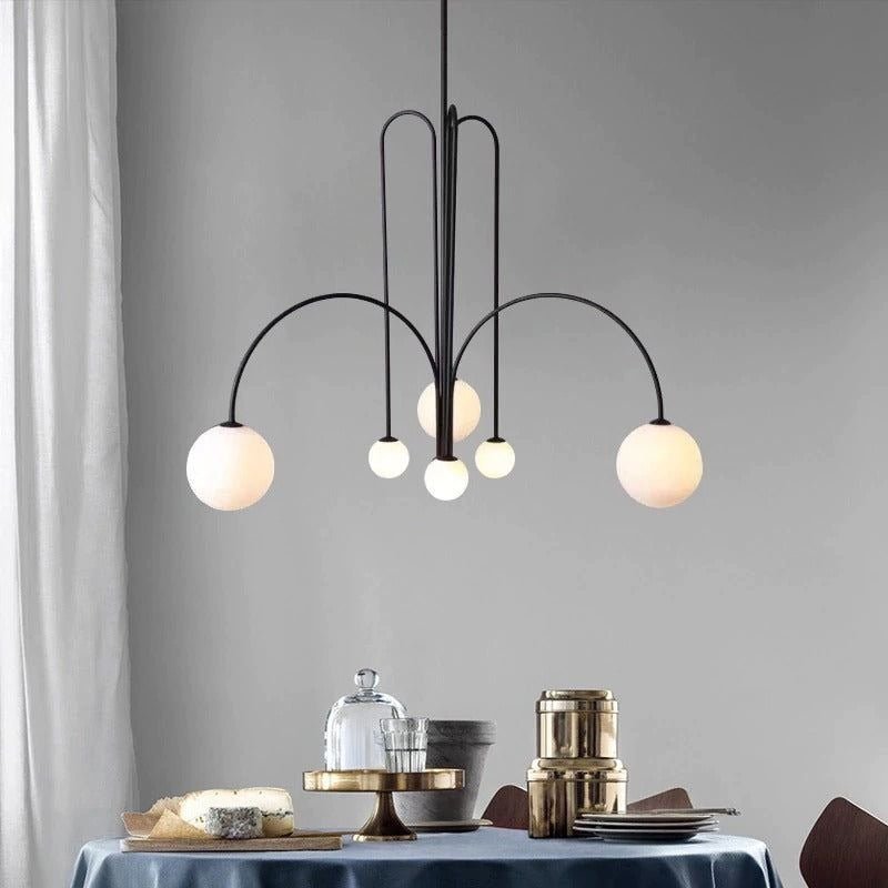 Globella 6-head pendant chandelier with glass globes, black metal arcs over dining table on Tampa Home & Garden Store