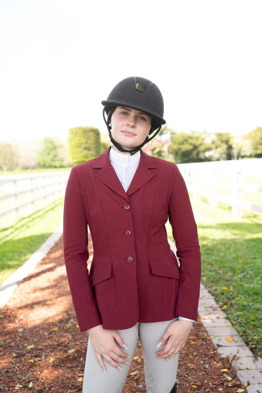 Grand Prix Ladies EQJ 3-Button Show Coat in burgundy NY Tech fabric by Huntley Equestrian, worn by rider with black helmet on Tampa Home & Garden Store