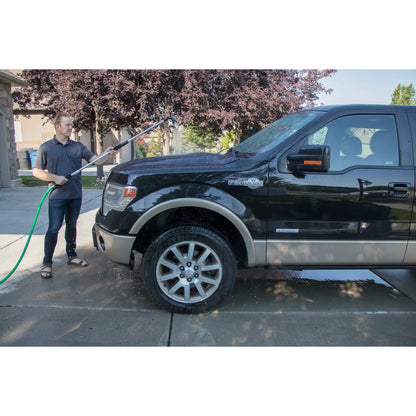 Telescoping Gutter Cleaning Wand with 180 nozzle used by man to rinse a black truck in driveway on Tampa Home & Garden Store