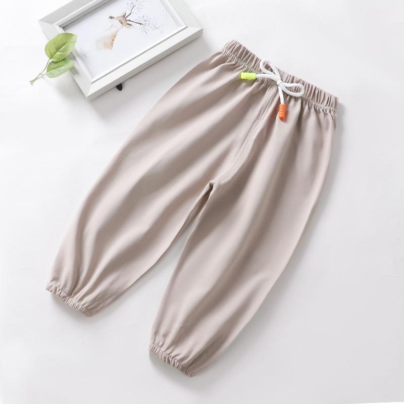 Stevvex baby anti-mosquito pajama pants in light beige with white drawstring and neon green/orange tips, elastic cuffs on Tampa Home & Garden Store