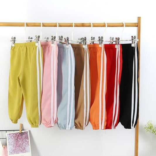 Kids sports pants by Stevvex in assorted colors with white side stripes on Tampa Home & Garden Store