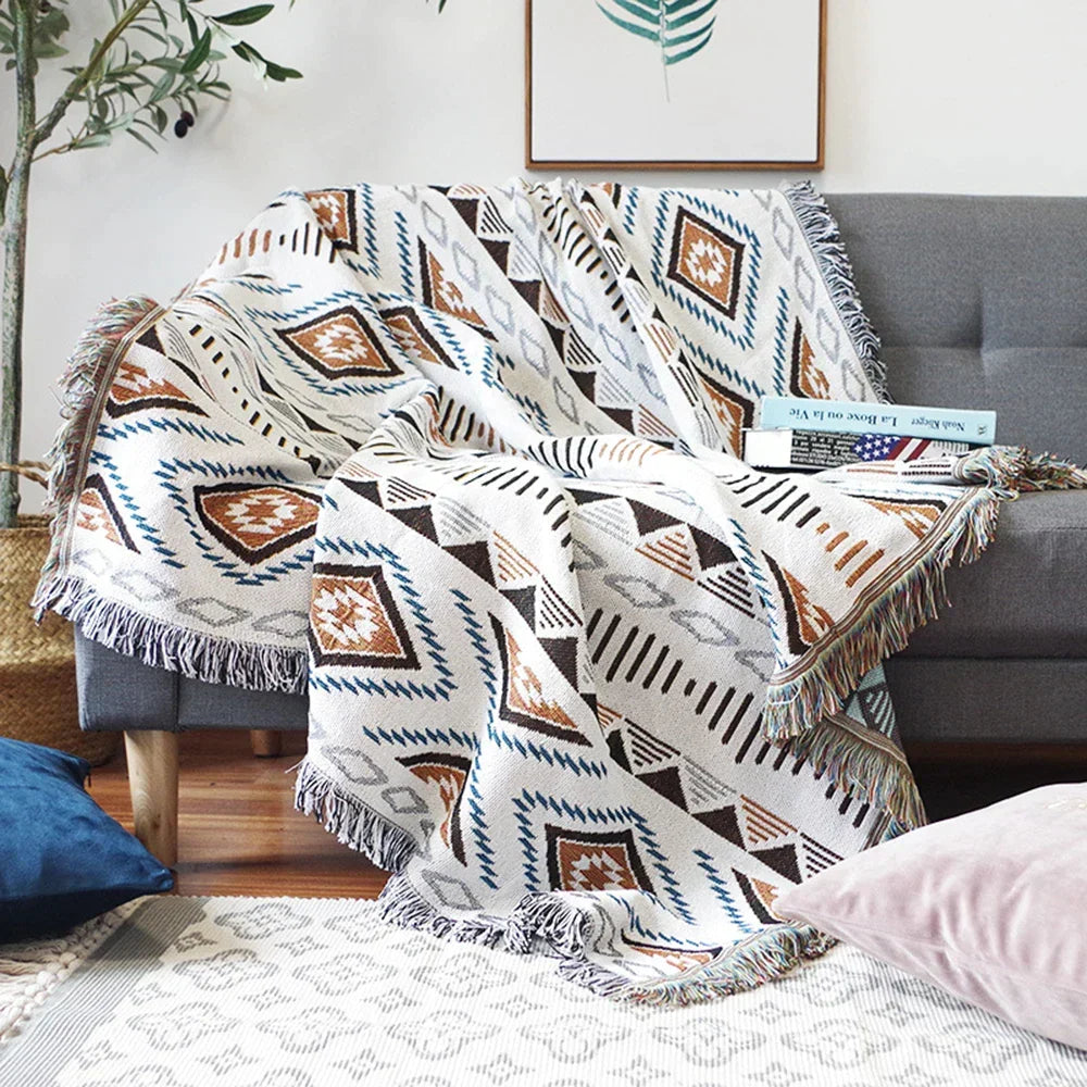 Decorbites Knitted Nordic Plaid Blanket in white with teal and brown geometric patterns on Tampa Home & Garden Store
