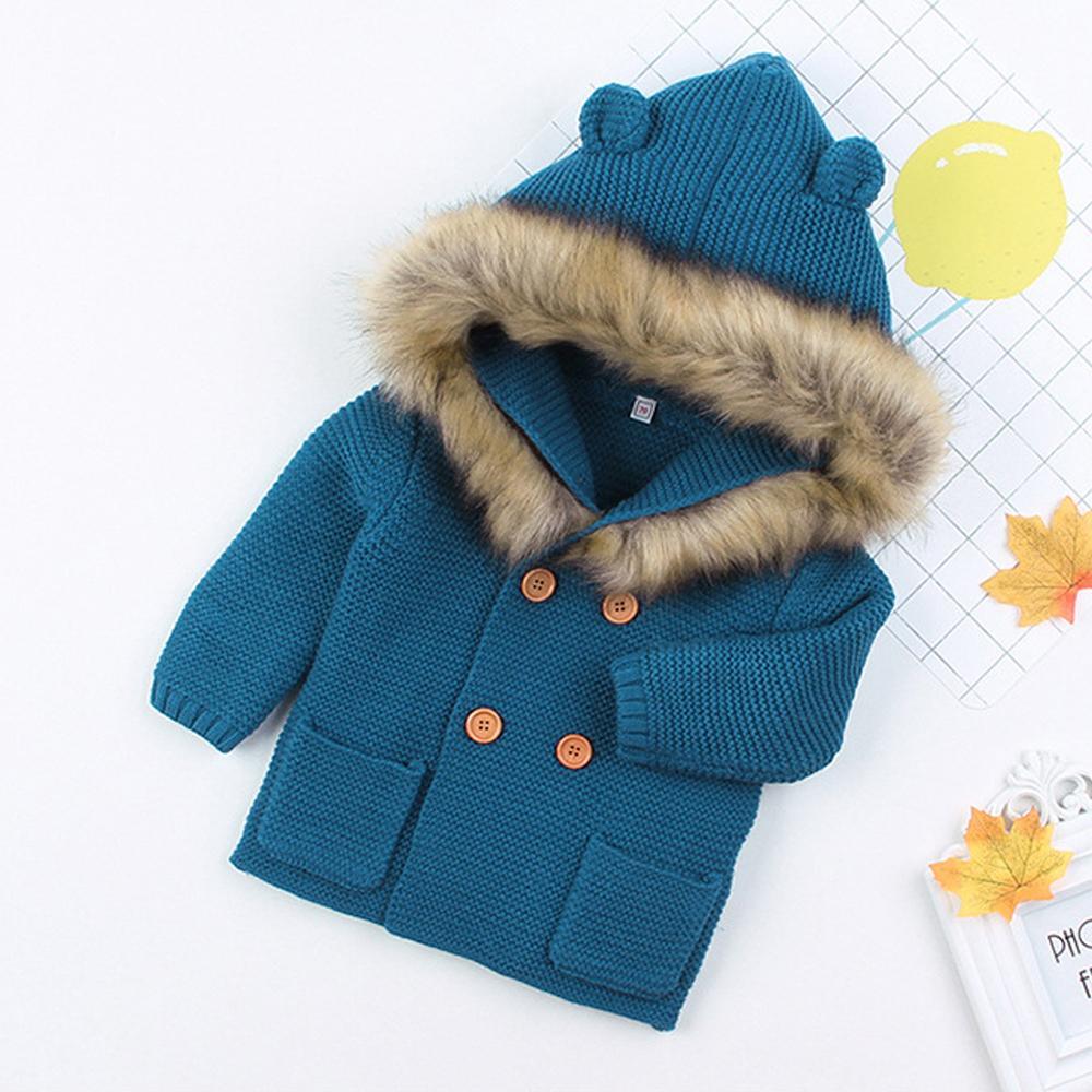 Knitted baby coat by Stevvex, blue with hood and faux fur trim, brown buttons, front pockets on Tampa Home & Garden Store