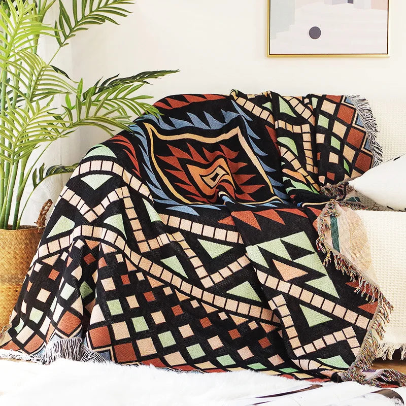 DecorBites knitted Nordic plaid blanket throw with geometric pattern and fringed edges over sofa on Tampa Home & Garden Store