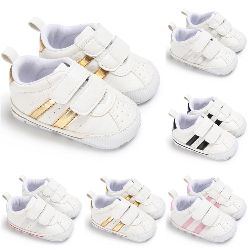 Set of 8 white Stevvex baby pre walker sneakers with hook loop straps and metallic accents on Tampa Home & Garden Store