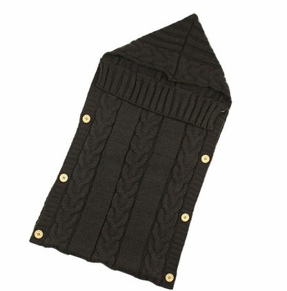 Knitted baby swaddle blanket by Stevvex with dark cable knit and wooden buttons along edges on Tampa Home & Garden Store