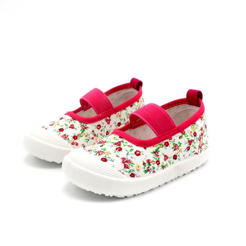 Pair of Stevvex baby girl canvas sneakers in white with candy floral prints, pink trim on Tampa Home & Garden Store