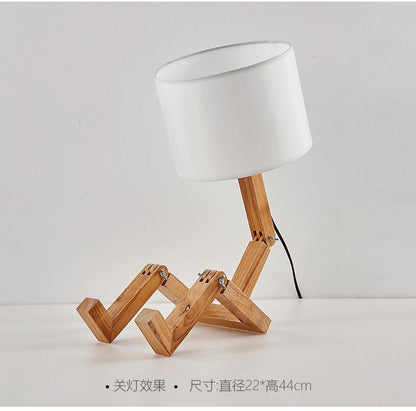 Stevvex ST5LM45021BBG wooden robot-shape folding table lamp with white linen shade on Tampa Home & Garden Store