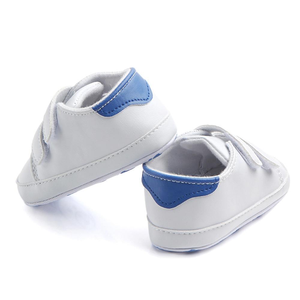 White leather baby shoes pair with blue heel patches, soft sole infant sneakers on Tampa Home & Garden Store