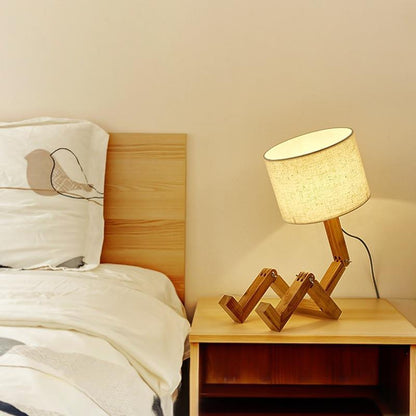 Stevvex wood robot shape folding table lamp with linen shade on bedside table on Tampa Home & Garden Store