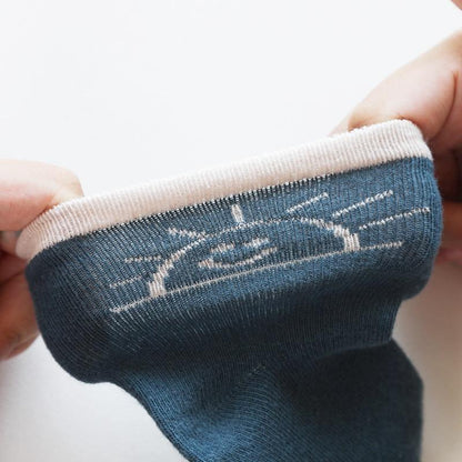Blue cotton newborn baby socks with white cuff and subtle stitched motif on Tampa Home & Garden Store