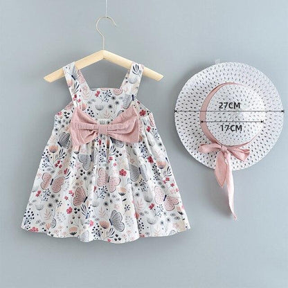 Baby girl dress and hat set with floral butterfly print and pink bow sash on a hanger on Tampa Home & Garden Store
