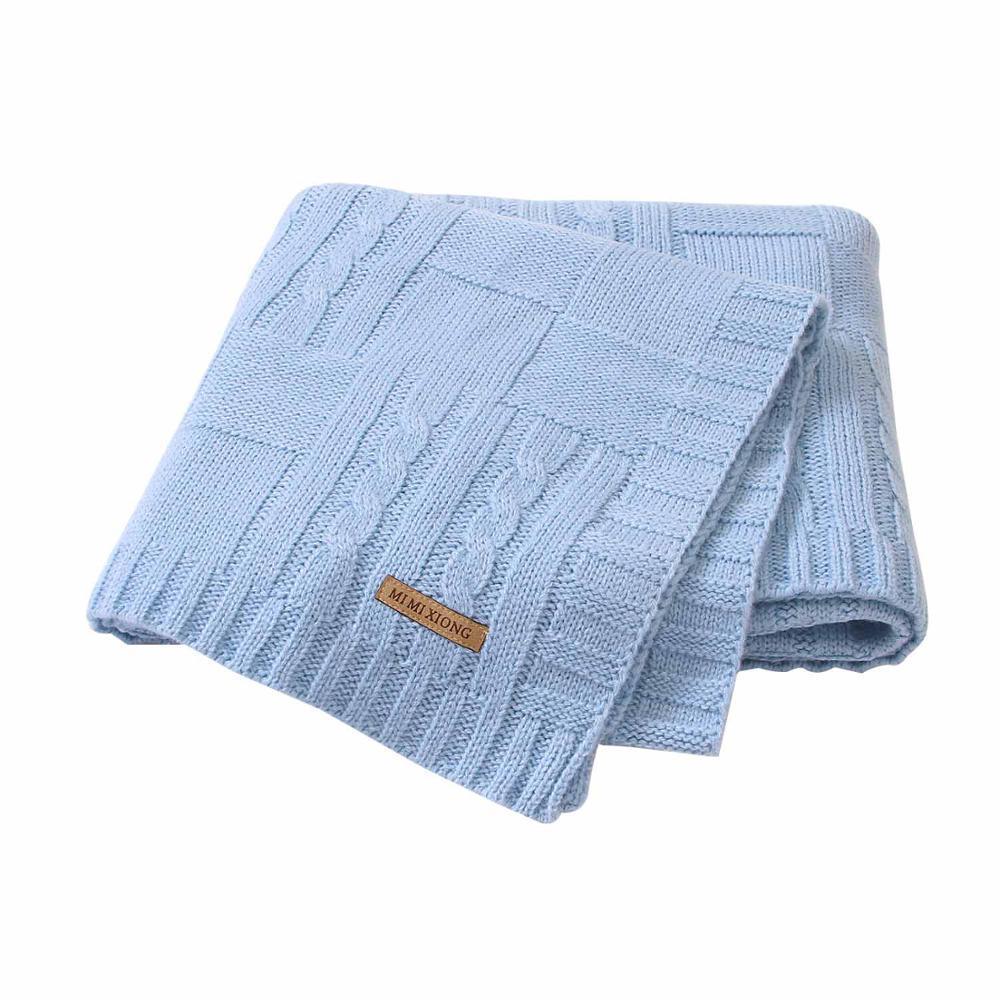 Light blue knitted baby swaddle blanket with cable-knit pattern and leather tag on Tampa Home & Garden Store
