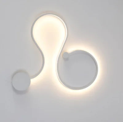 DecorBites LED aluminum wall lamp with abstract curved design and warm backlit glow on Tampa Home & Garden Store