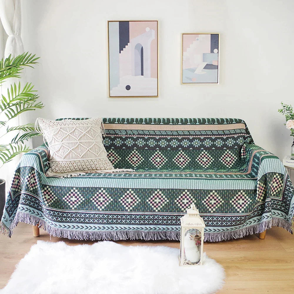 DecorBites Knitted Nordic Plaid Blanket draped over a teal-green sofa with geometric motifs on Tampa Home & Garden Store