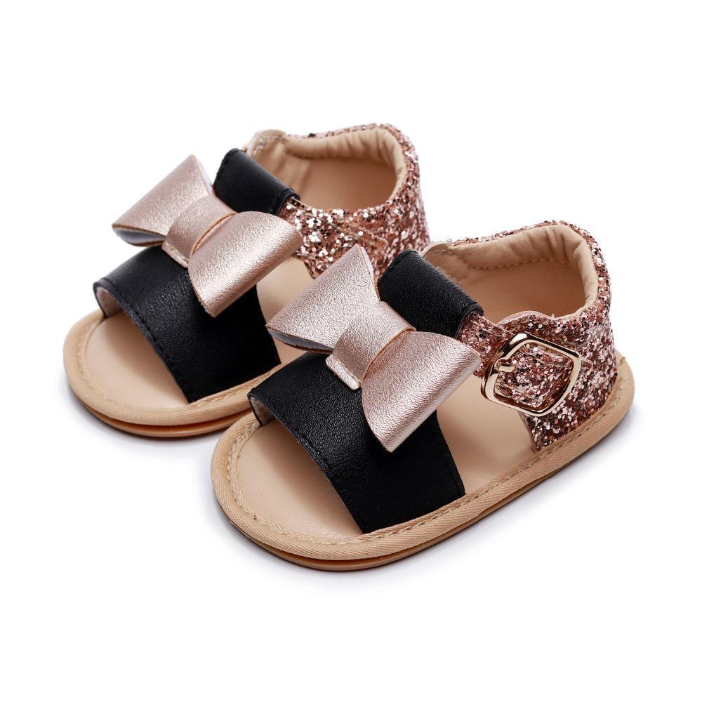 Baby girl sandals with black front strap and rose gold bow, glitter pink back strap with buckle on Tampa Home & Garden Store