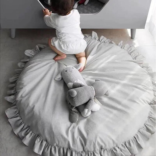 Round gray baby play mat, padded cotton with frilled edge and plush toy on Tampa Home & Garden Store