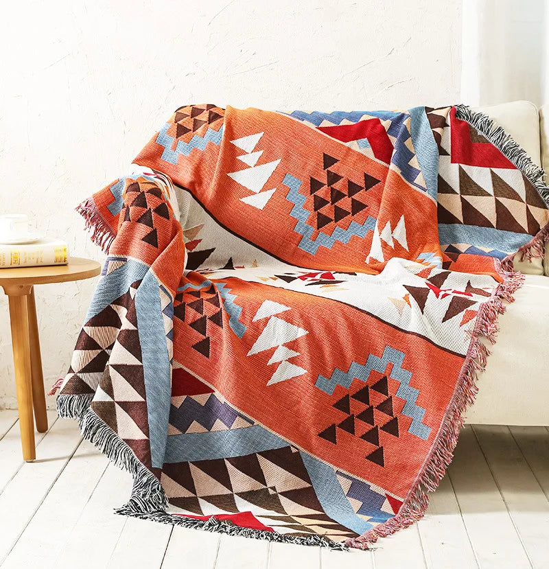 DecorBites Knitted Nordic Plaid Blanket with orange blue white geometric pattern and fringe on Tampa Home & Garden Store