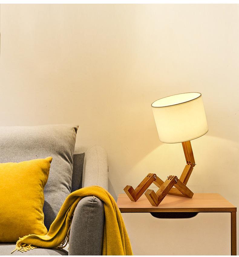 Stevvex wood robot-shaped folding table lamp with linen shade on a light wood nightstand on Tampa Home & Garden Store