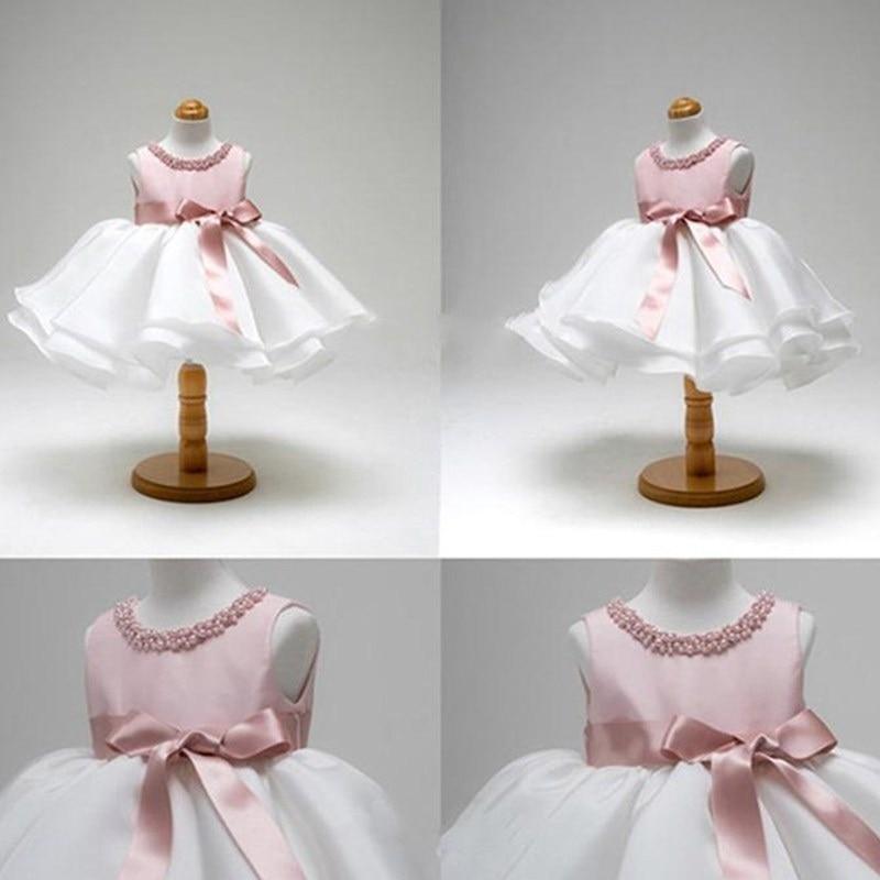 Baby christening dress by Stevvex, pink bodice, white skirt, pink sash, 4-view collage on Tampa Home & Garden Store
