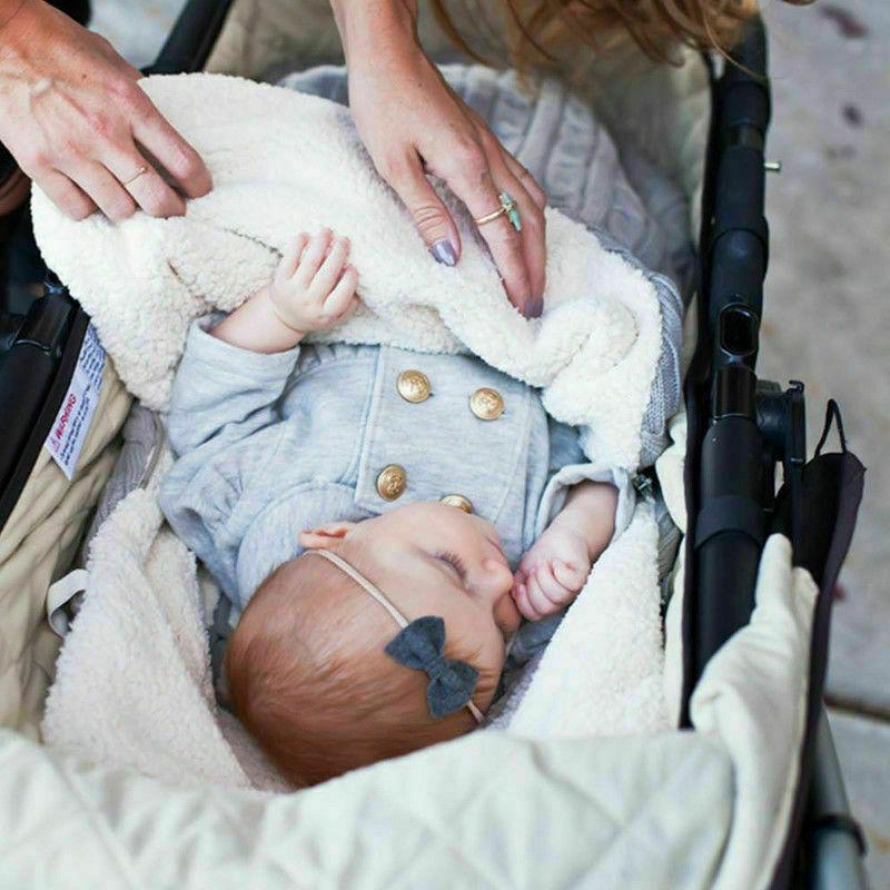 Stevvex warm baby blanket knitted swaddle wrap in fluffy white blanket, baby in stroller on Tampa Home & Garden Store
