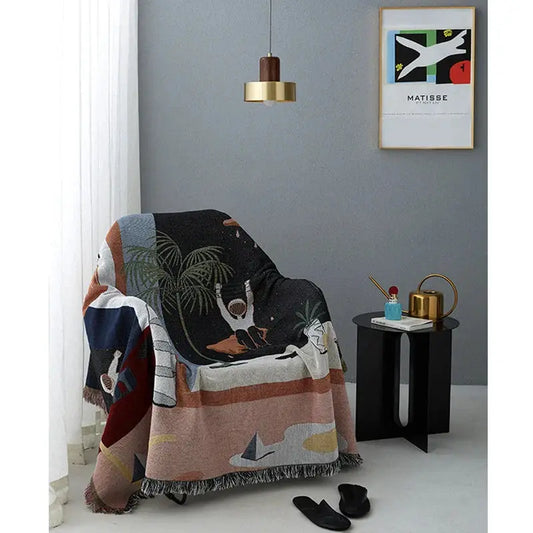 Nordic throw blanket draped over an armchair; palm motif with fringe by VIP Digital Presence on Tampa Home & Garden Store