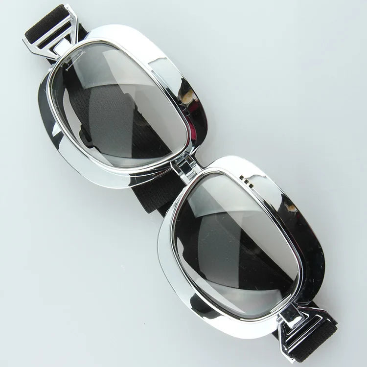 Pair of chrome-framed motorcycle goggles with black elastic strap by BikerZoneZ on Tampa Home & Garden Store