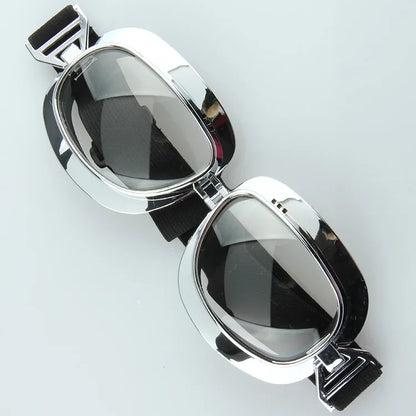 Pair of chrome-framed motorcycle goggles with black elastic strap by BikerZoneZ on Tampa Home & Garden Store